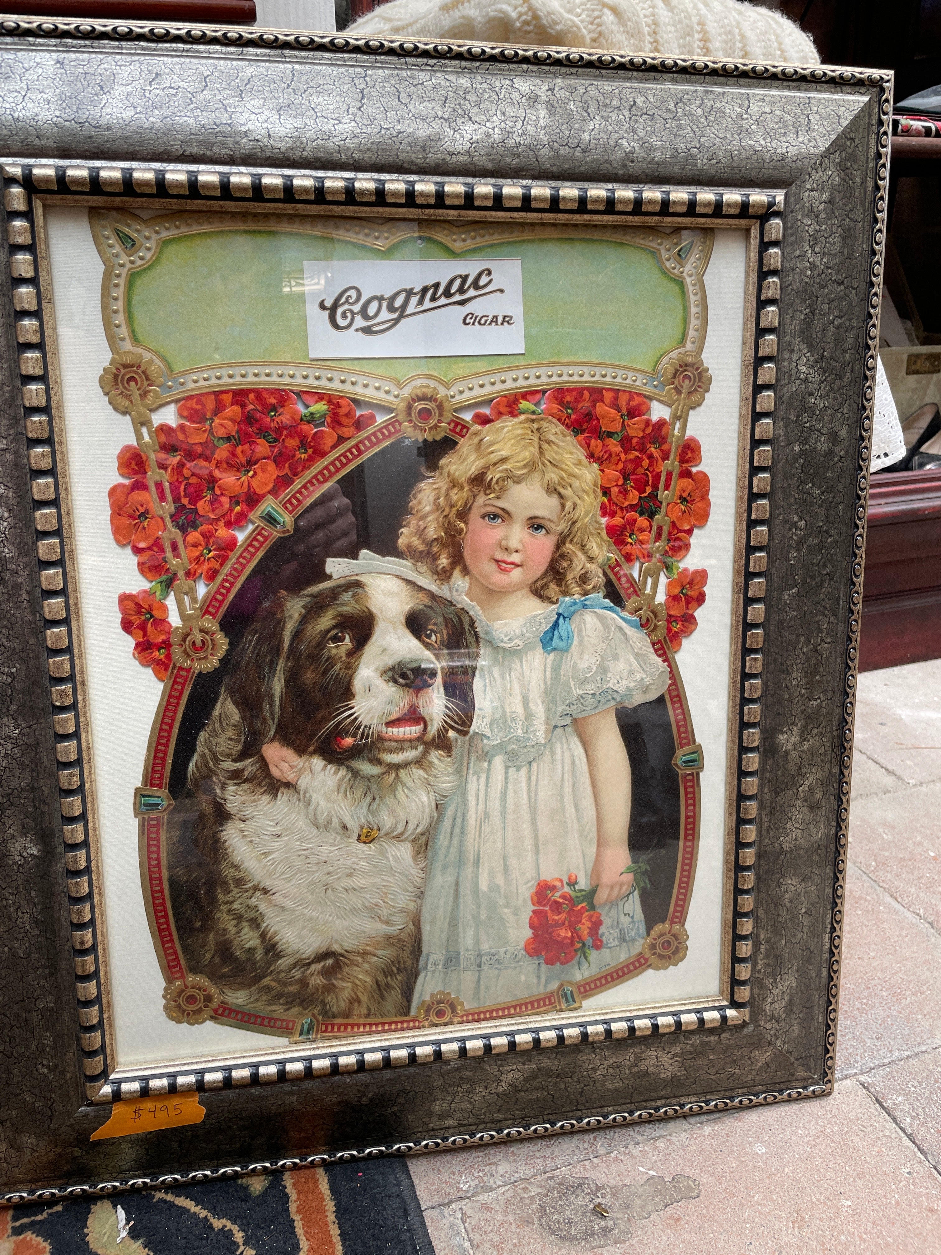 Circa 1900 Original Cognac Cigar Antique Advertising die cut sign depicting a Victorian Girl with Dog. Excellent condition in an ornate frame!
